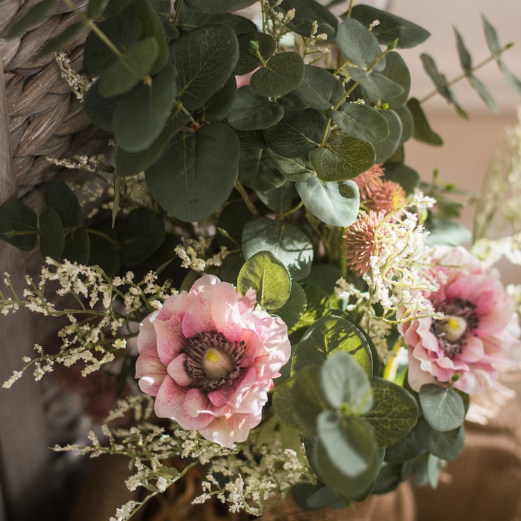 A beautiful handmade artificial flower bouquet featuring pink anemones and green eucalyptus, standing 21 inches tall.