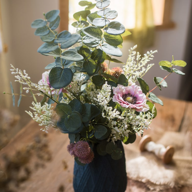 A beautiful handmade artificial flower bouquet featuring pink anemones and green eucalyptus, standing 21 inches tall.