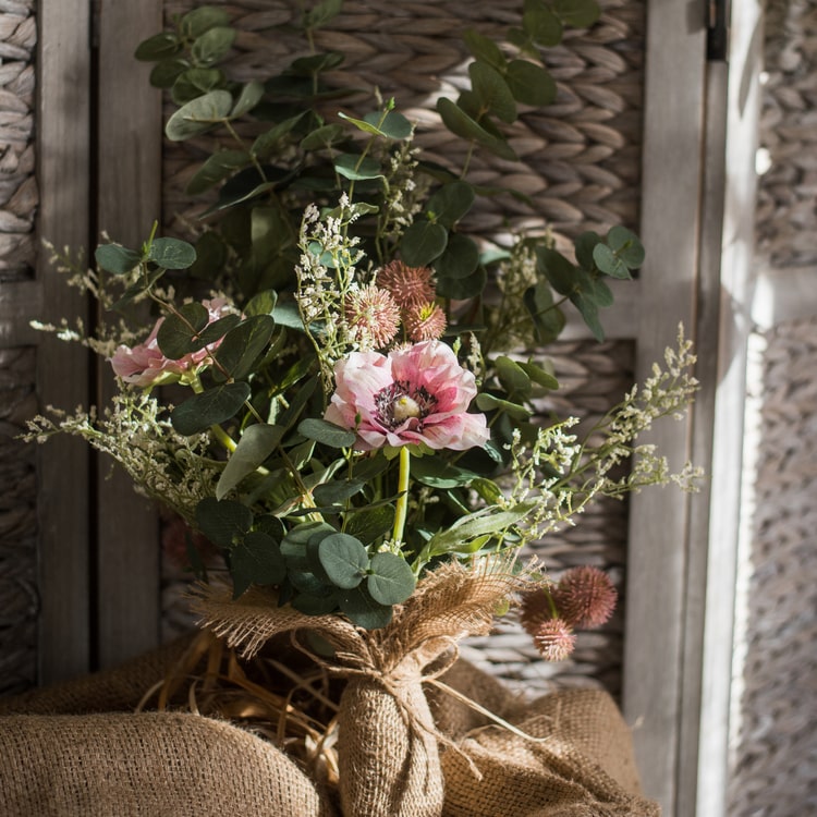 A beautiful handmade artificial flower bouquet featuring pink anemones and green eucalyptus, standing 21 inches tall.