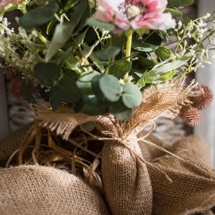 A beautiful handmade artificial flower bouquet featuring pink anemones and green eucalyptus, standing 21 inches tall.