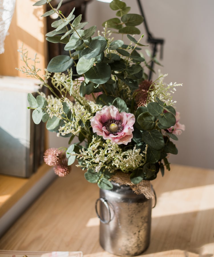 A beautiful handmade artificial flower bouquet featuring pink anemones and green eucalyptus, standing 21 inches tall.