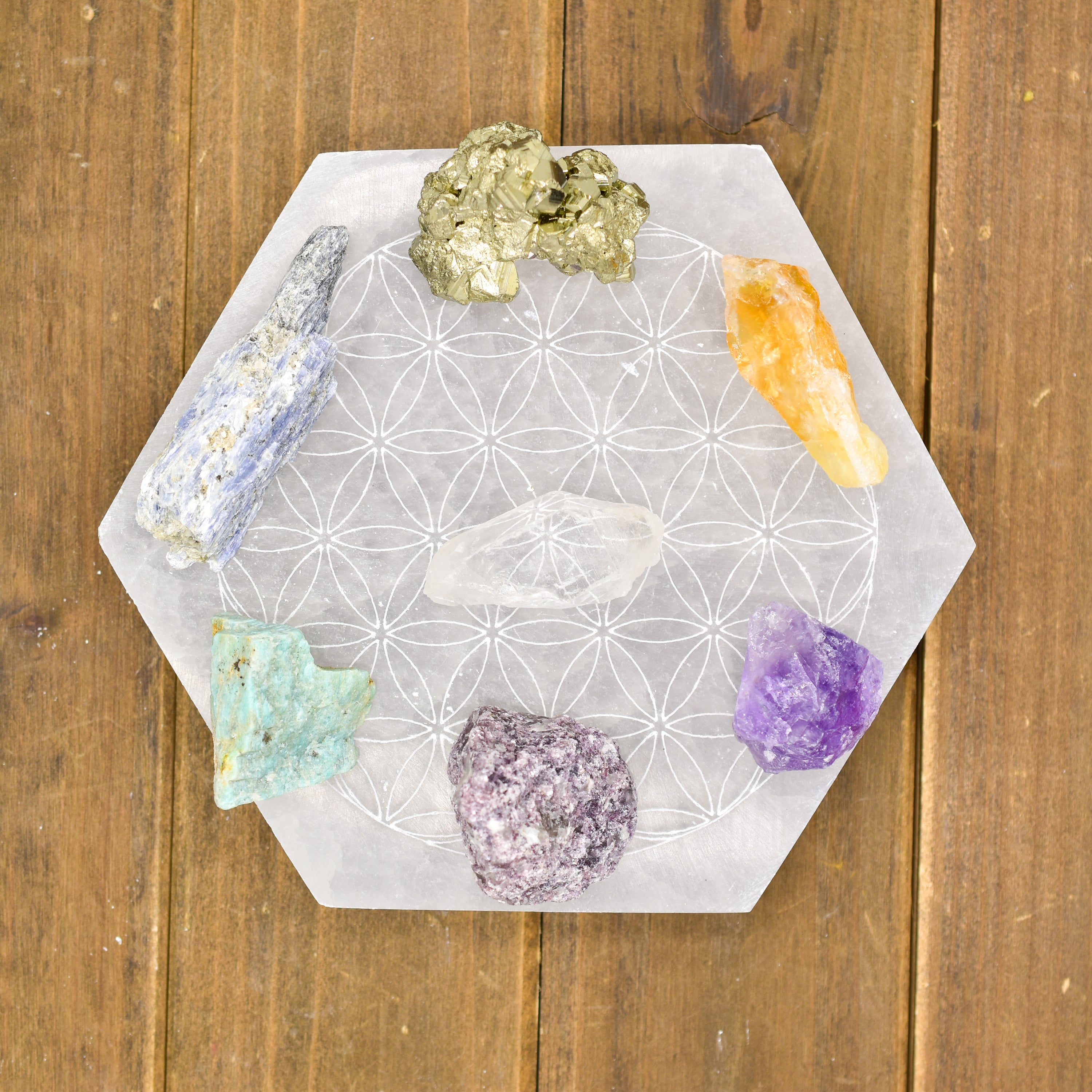 Flower of Life Laser Engraved Selenite Plates in hexagon and round shapes, polished finish, ideal for crystal charging.