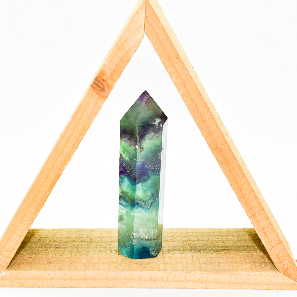 A beautifully polished Fluorite Crystal Point showcasing vibrant colors and unique patterns, ideal for energy healing and meditation.