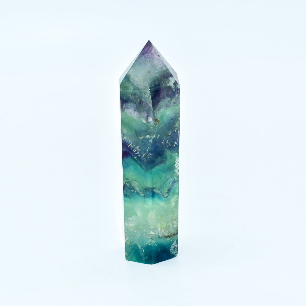 A beautifully polished Fluorite Crystal Point showcasing vibrant colors and unique patterns, ideal for energy healing and meditation.