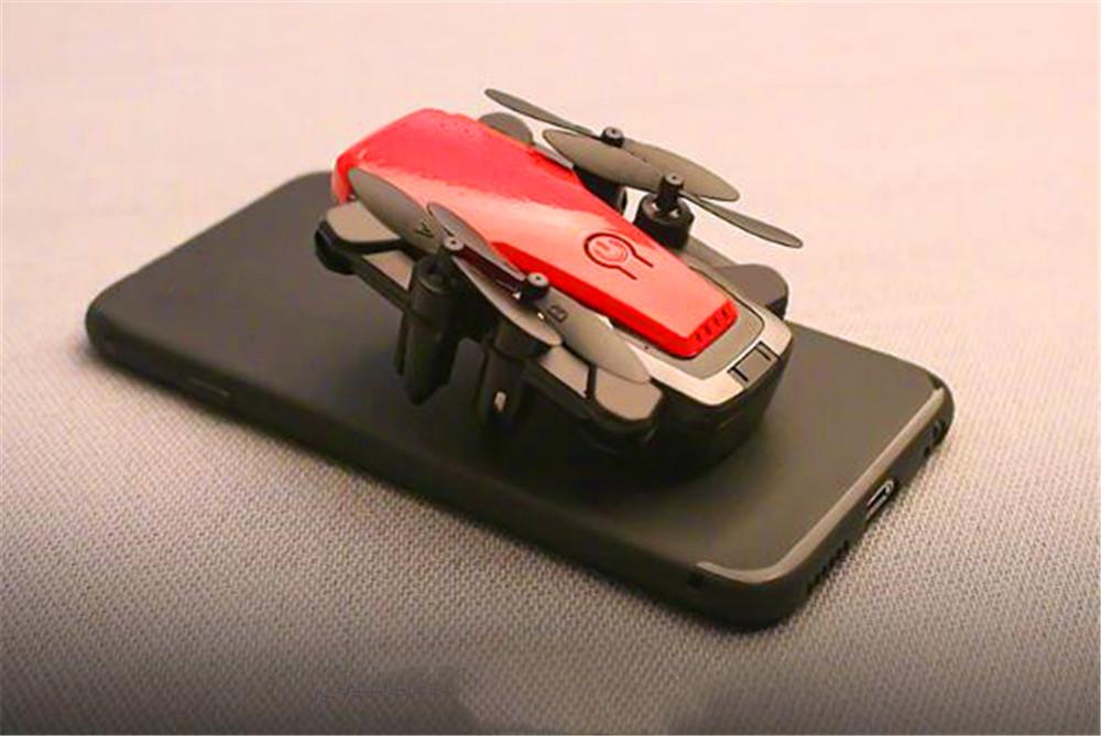 Foldable Mini Drone with HD camera in flight, showcasing its compact design and advanced features.