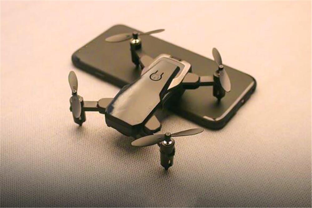 Foldable Mini Drone with HD camera in flight, showcasing its compact design and advanced features.