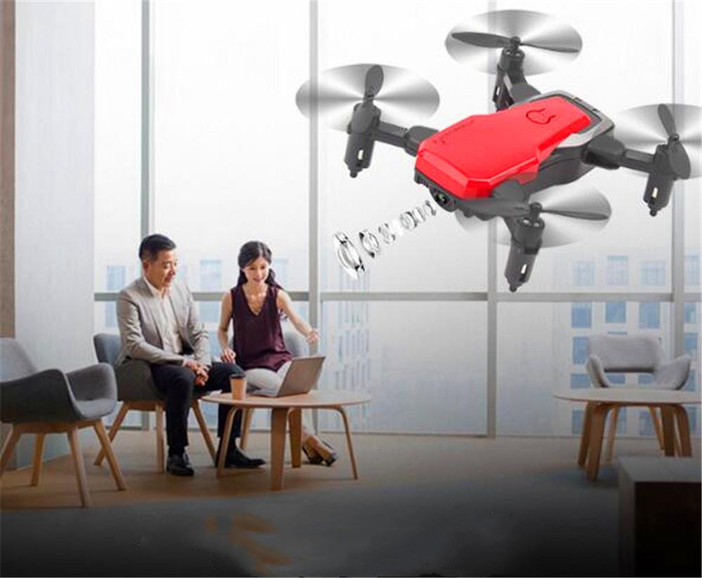 Foldable Mini Drone with HD camera in flight, showcasing its compact design and advanced features.