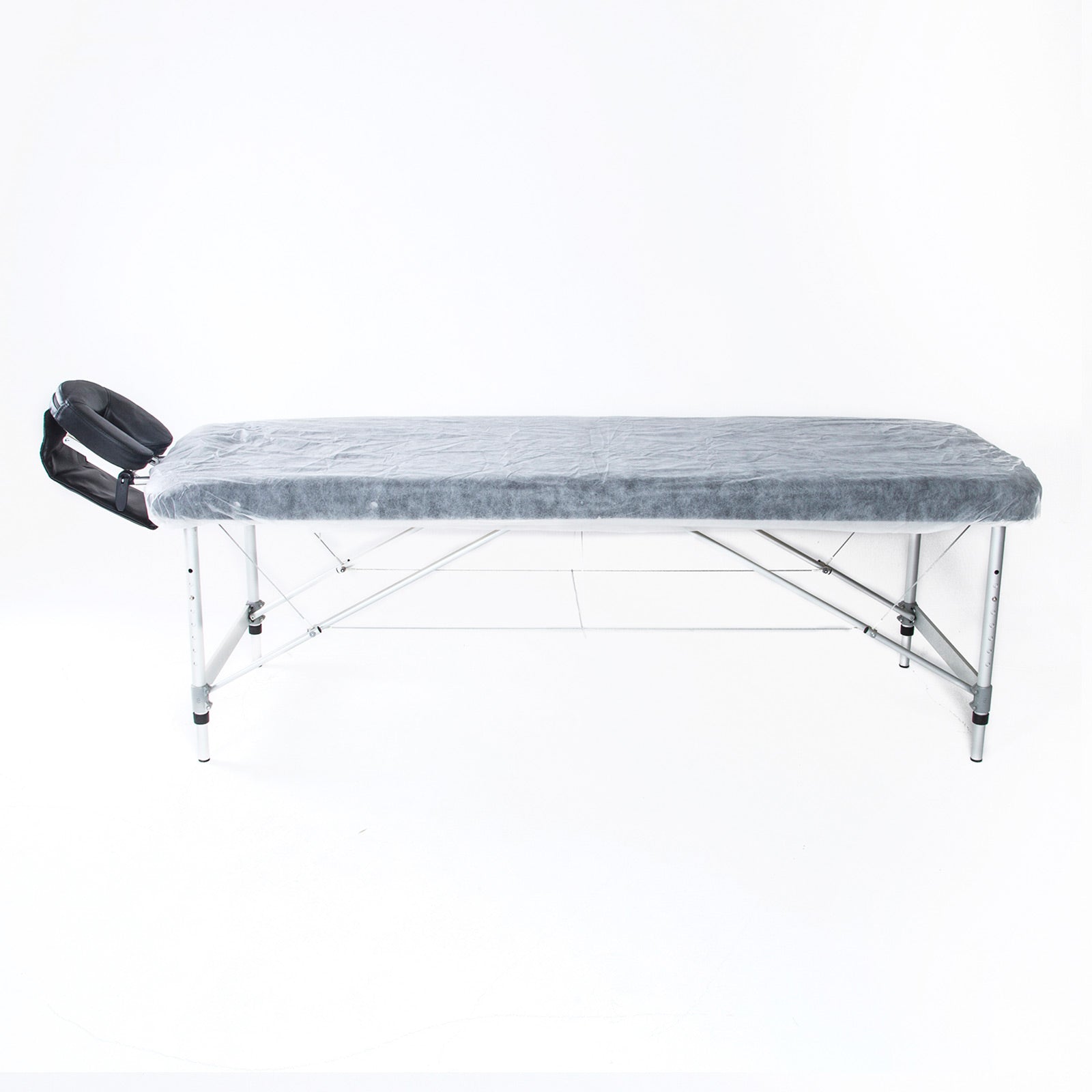 A pack of 60 disposable massage table sheet covers, white non-woven fabric, designed for hygienic use in therapy settings, measuring 180cm x 75cm.