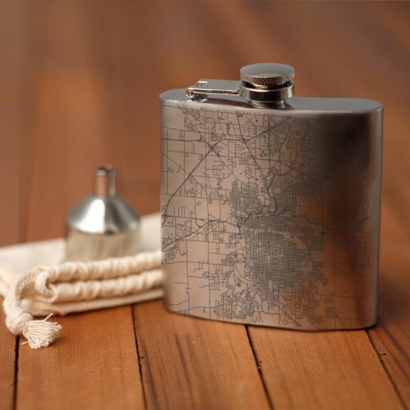 Custom engraved 6oz hip flask featuring a detailed map of Fort Wayne, Indiana, with coordinates, accompanied by a canvas bag and funnel.