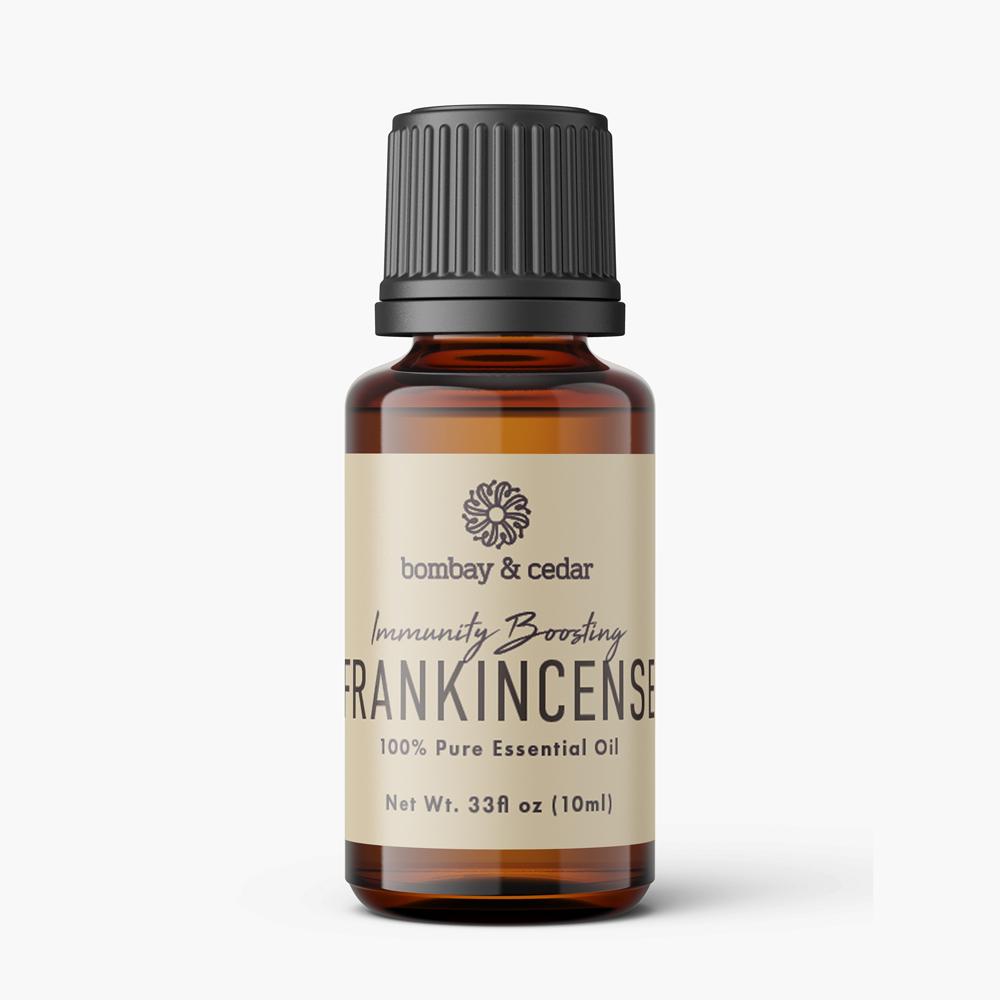 10ml bottle of Frankincense Essential Oil with a dropper, surrounded by natural elements.