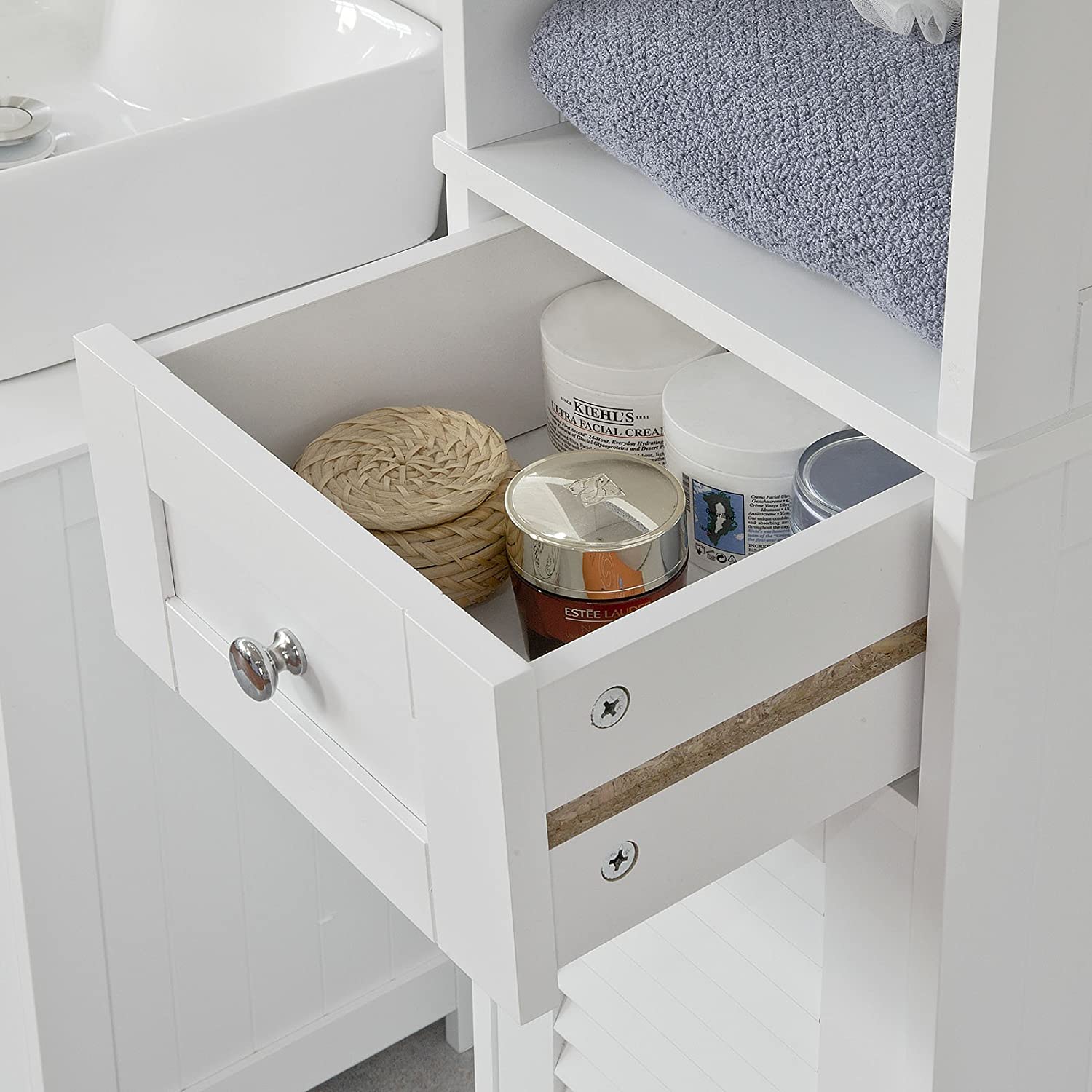 Freestanding Tall Bathroom Cabinet in white with two shutter doors and a drawer, showcasing adjustable shelves inside.