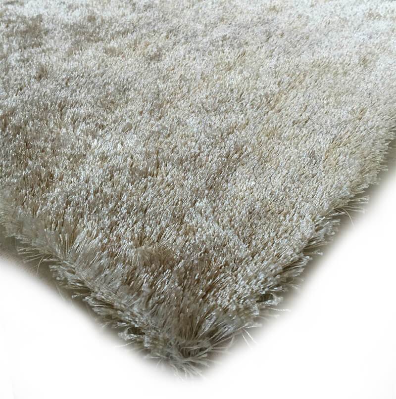 Fuzzy Beige Area Rug showcasing a soft shaggy texture, perfect for home decor.