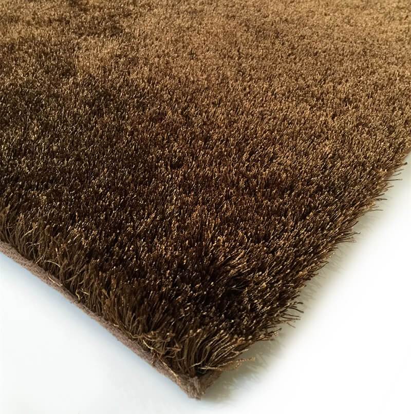 Fuzzy Brown Area Rug showcasing a soft shaggy texture, perfect for enhancing home decor with warmth and comfort.