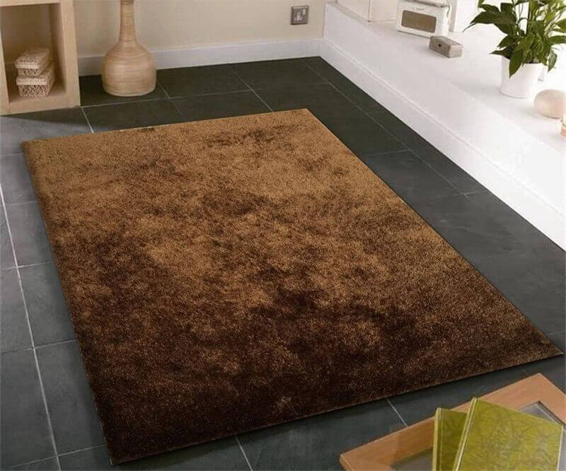 Fuzzy Brown Area Rug showcasing a soft shaggy texture, perfect for enhancing home decor with warmth and comfort.