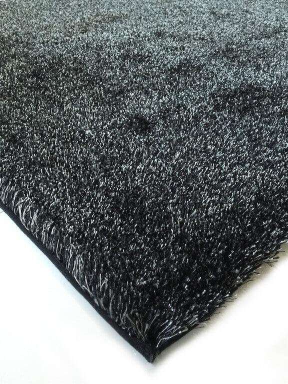 Fuzzy Two Tone Black Ash Area Rug showcasing a soft shaggy texture in black and rust colors, perfect for enhancing home decor.