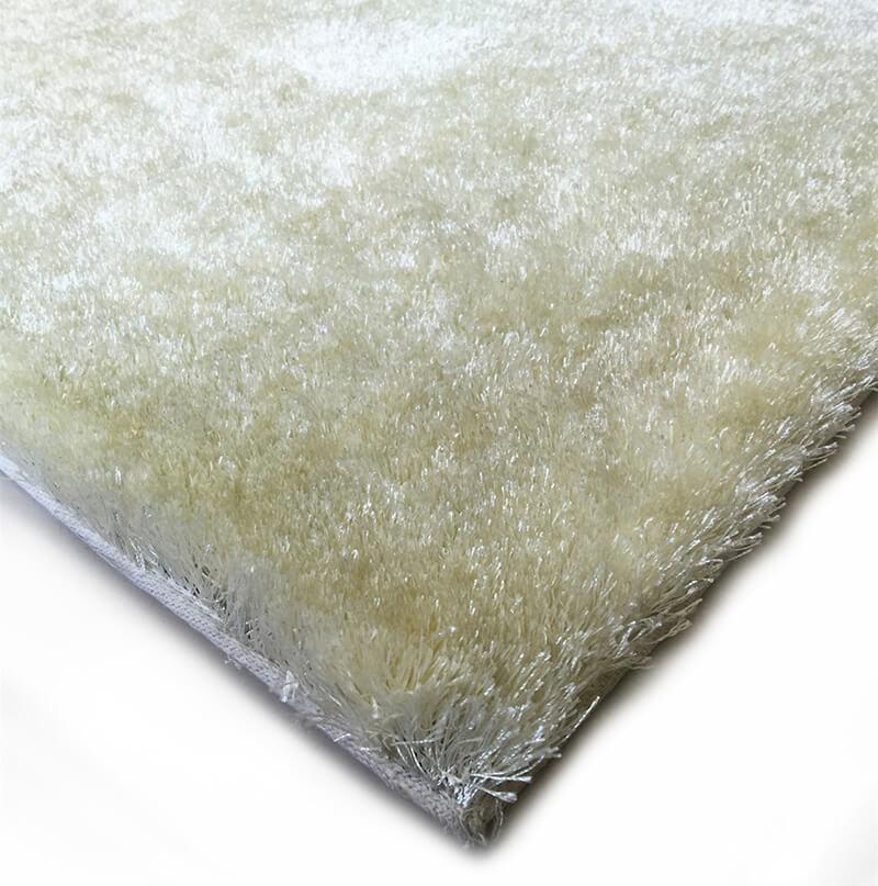 Fuzzy White Area Rug in pearl white color, showcasing its soft shaggy texture and cotton backing, perfect for enhancing home decor.