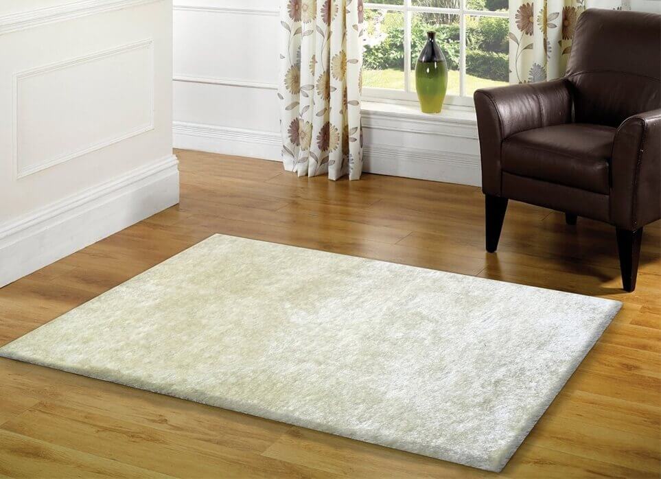 Fuzzy White Area Rug in pearl white color, showcasing its soft shaggy texture and cotton backing, perfect for enhancing home decor.