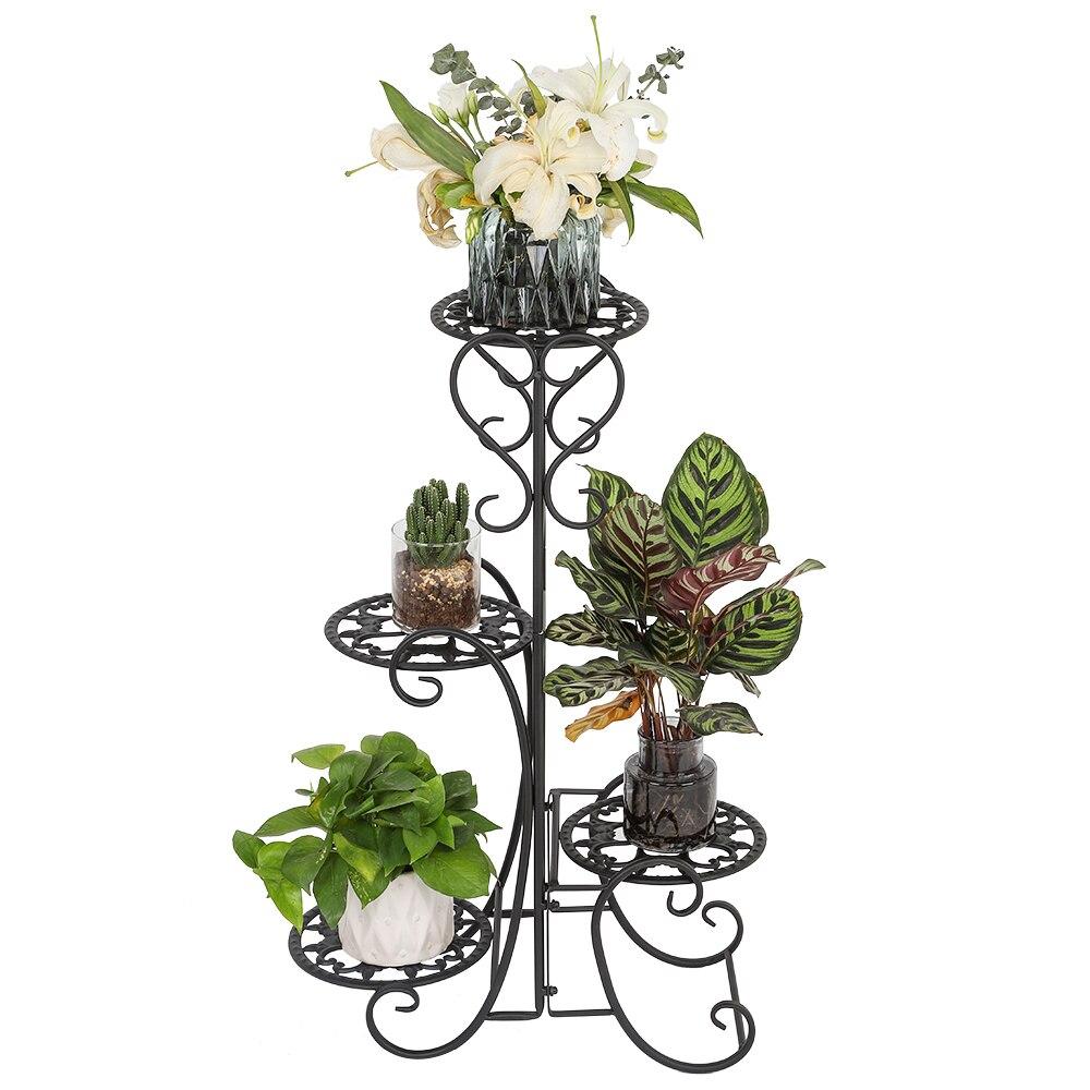 A stylish black metal garden flower stand with four rounded shelves, displaying various potted plants in an outdoor setting.