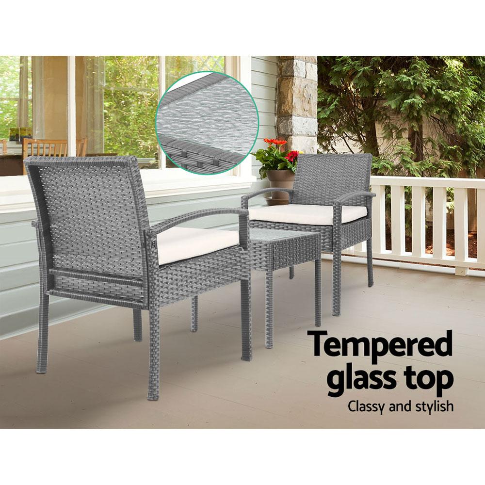 Gardeon 3-piece outdoor set in grey featuring two chairs and a side table with a glass top, showcasing elegant design and comfortable cushions.