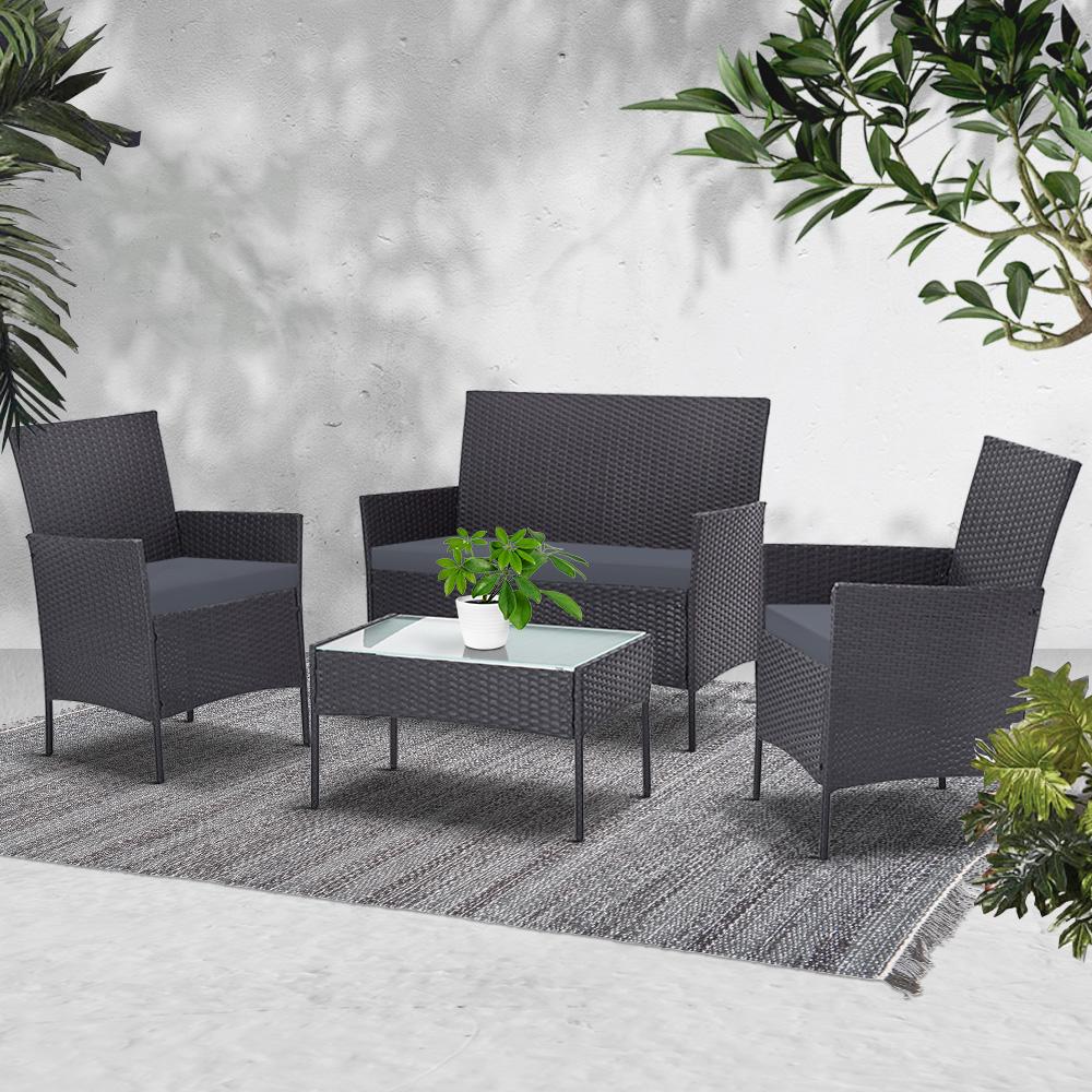 Gardeon 4-piece outdoor lounge setting featuring a chic loveseat, two armchairs, and a matching side table with a glass top, set in a stylish outdoor environment.