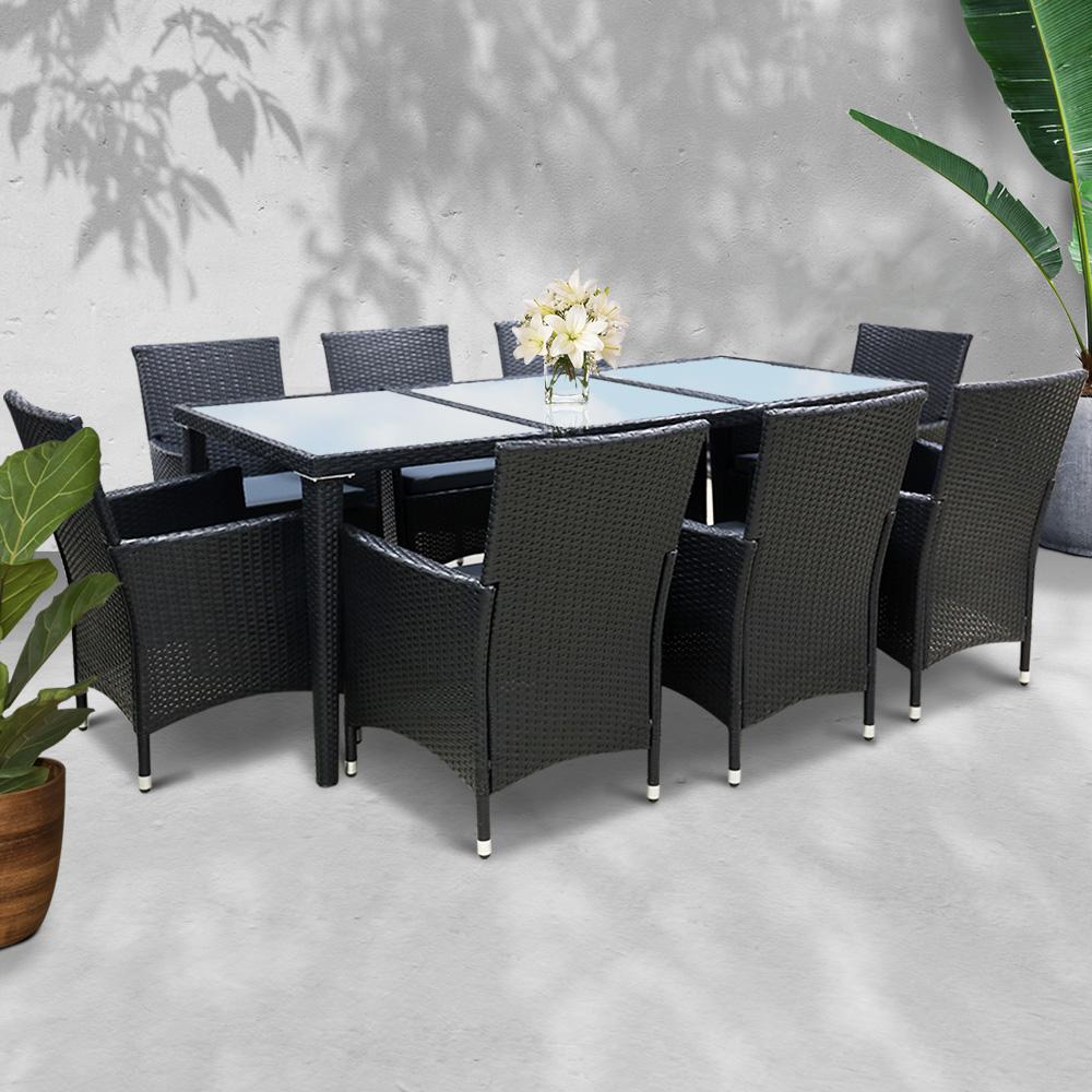 Gardeon 9 Piece Outdoor Dining Set in Black featuring eight chairs and a spacious table with a tempered glass top, set in an outdoor environment.