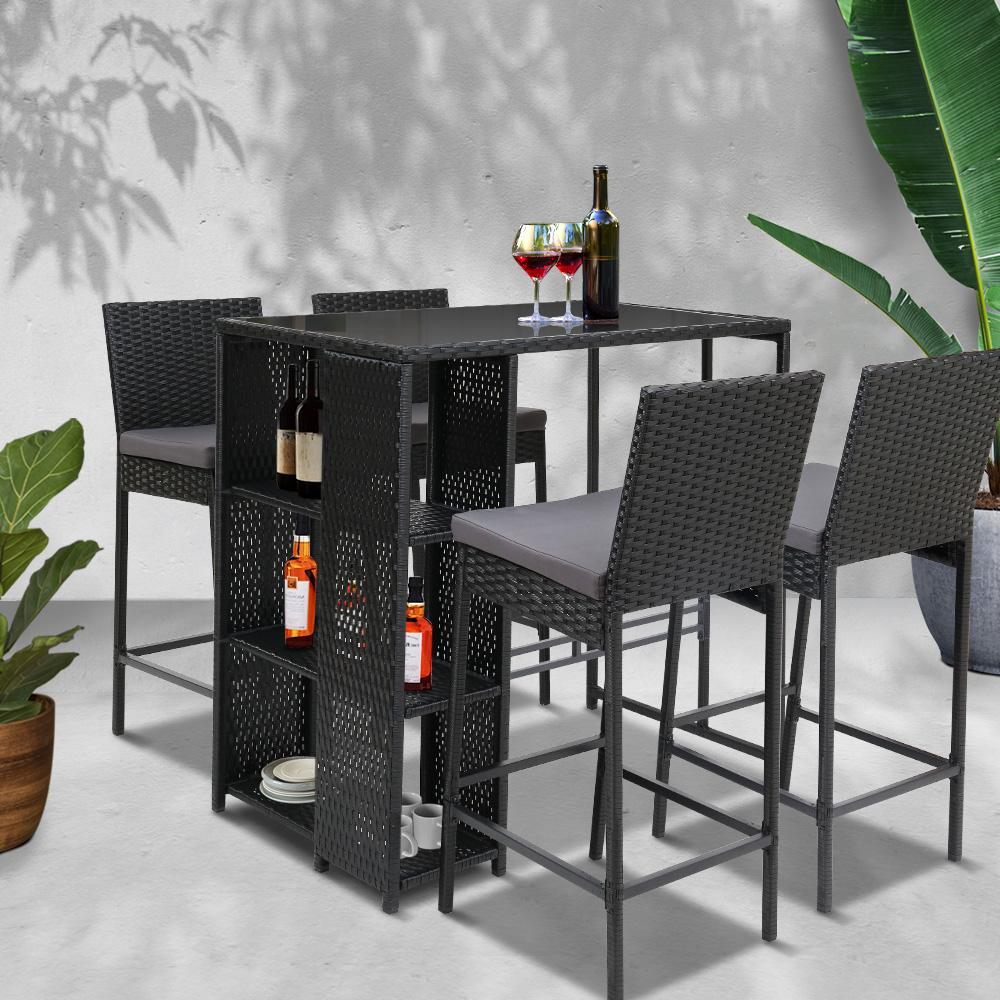 Gardeon Outdoor Bar Set featuring a stylish table and four wicker stools with grey cushions, perfect for outdoor dining.