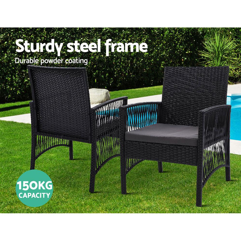 Gardeon Outdoor Furniture Dining Chairs with wicker design and grey cushions, set around a glass-top table in a garden setting.