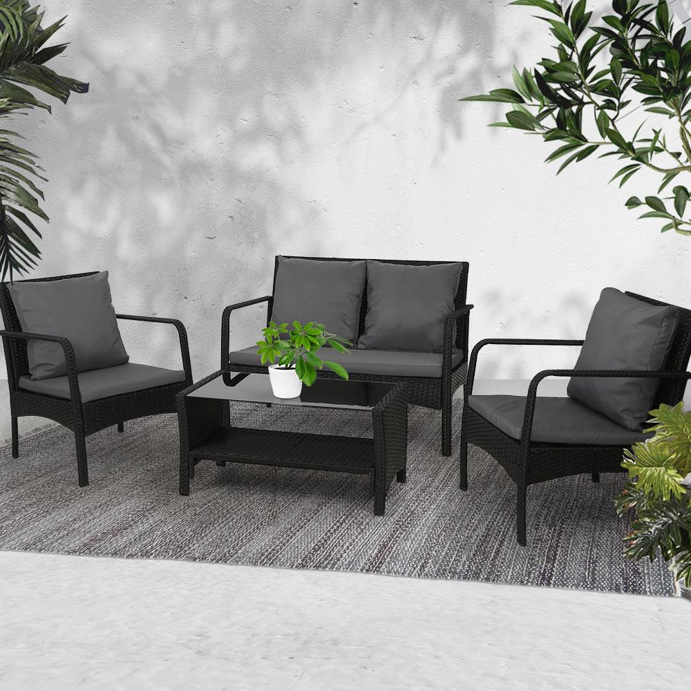 Gardeon Outdoor Furniture Lounge Set featuring two armchairs, a loveseat, and a table with cushions in a stylish garden setting.