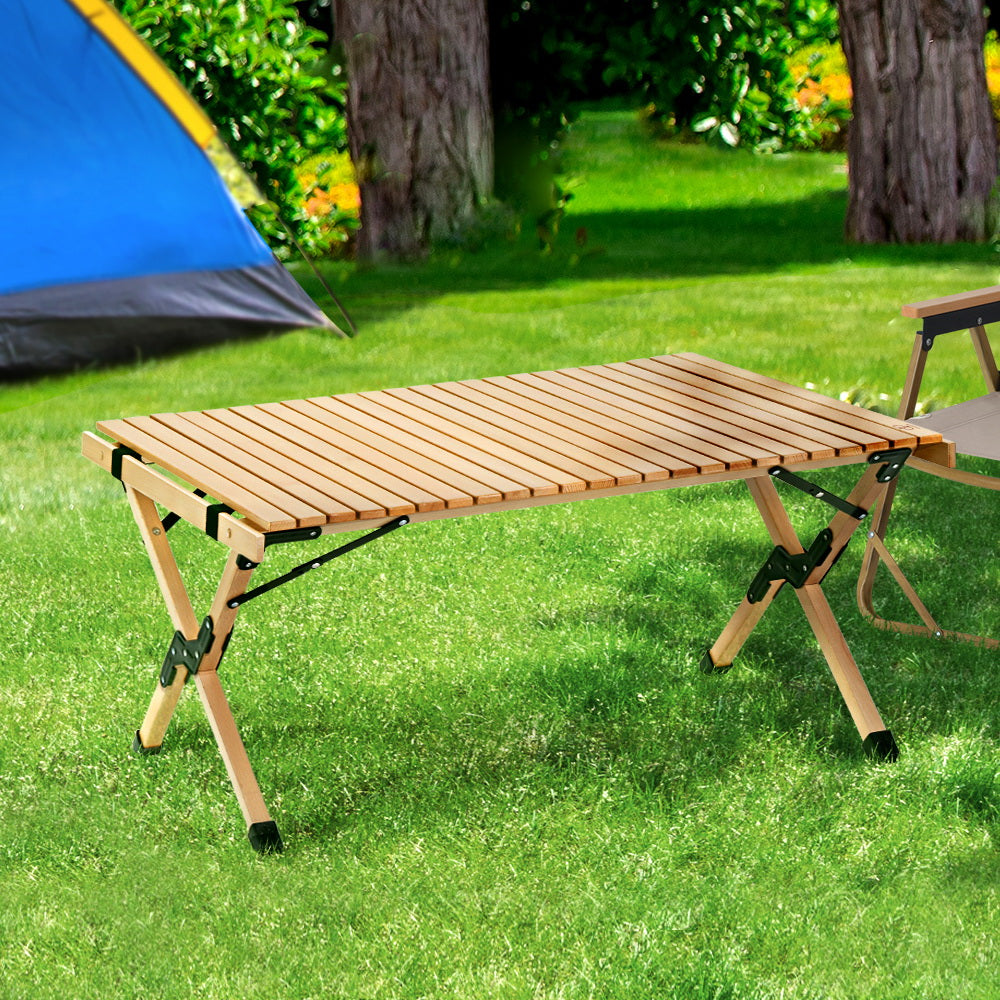 Gardeon Outdoor Furniture Wooden Egg Roll Picnic Table set up in a natural outdoor setting, showcasing its beech wood finish and lightweight design.