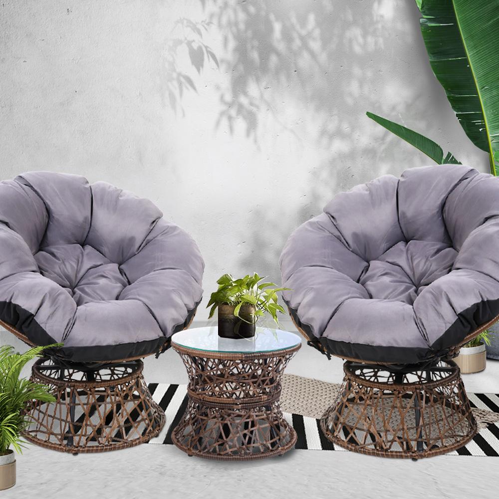 Gardeon Outdoor Lounge Setting featuring two Papasan chairs with thick cushions and a round side table with tempered glass top, set in a garden.