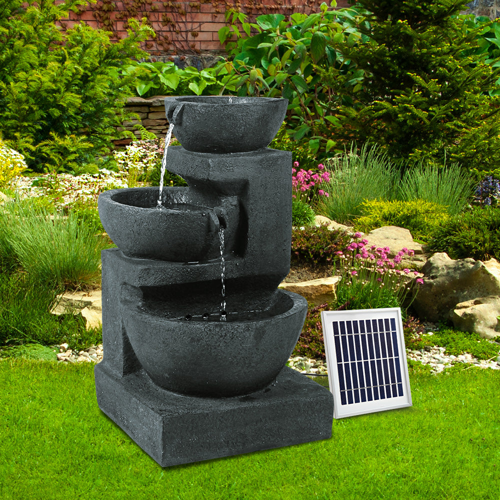 Gardeon Solar Fountain with LED lights, featuring a three-tier design and vibrant blue color, set in a garden environment.