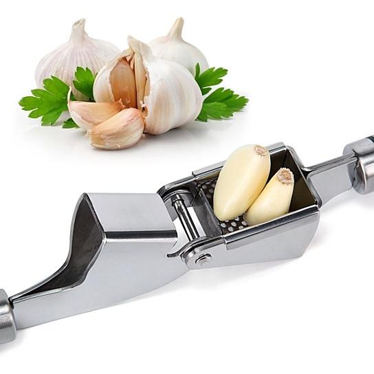 Stainless steel Garlic Press PRO with silicone peeler and cleaning brush, designed for easy garlic mincing.