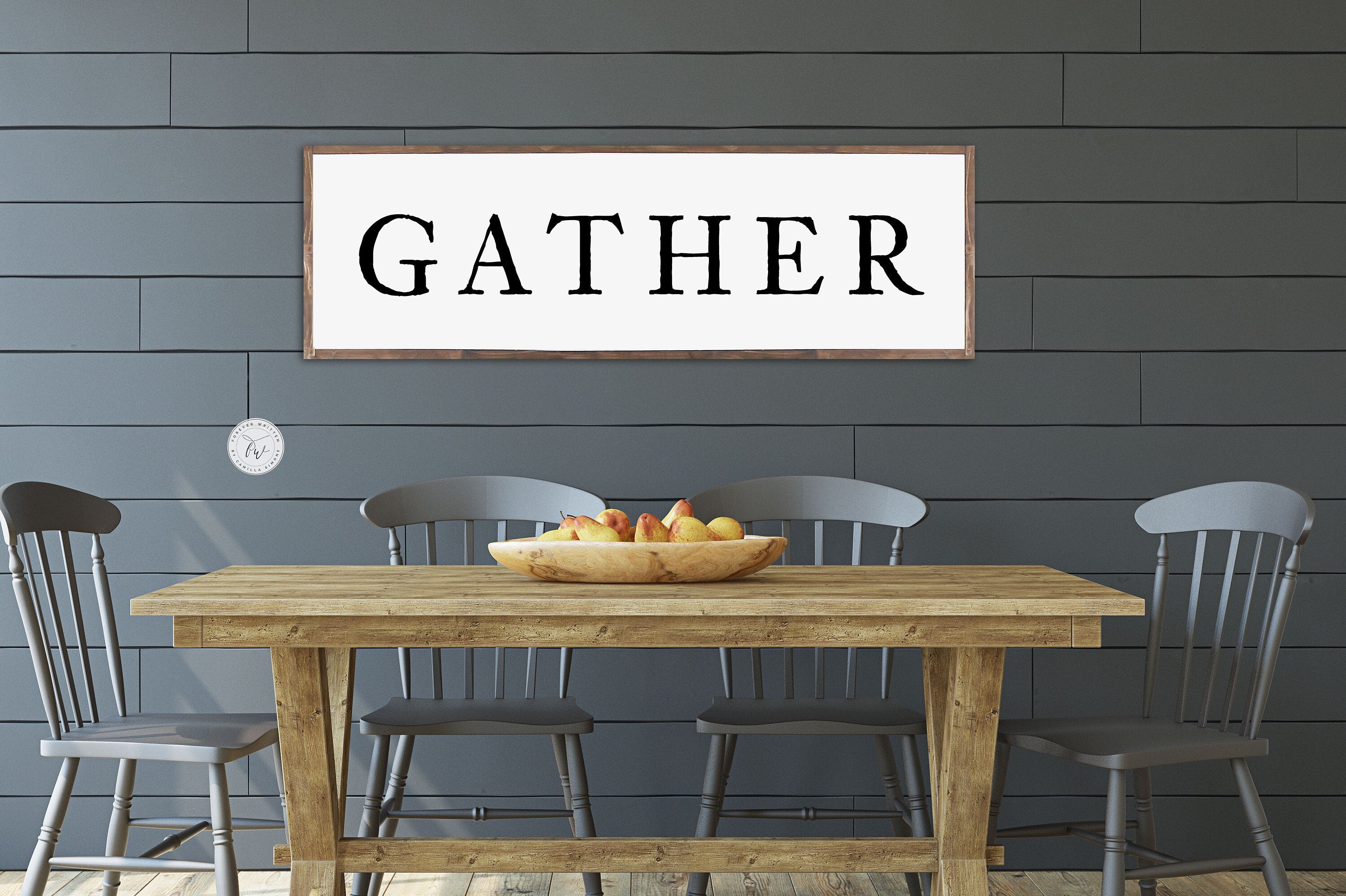 Gather Farmhouse Wood Sign featuring rustic wood grain and painted lettering, perfect for dining room decor.