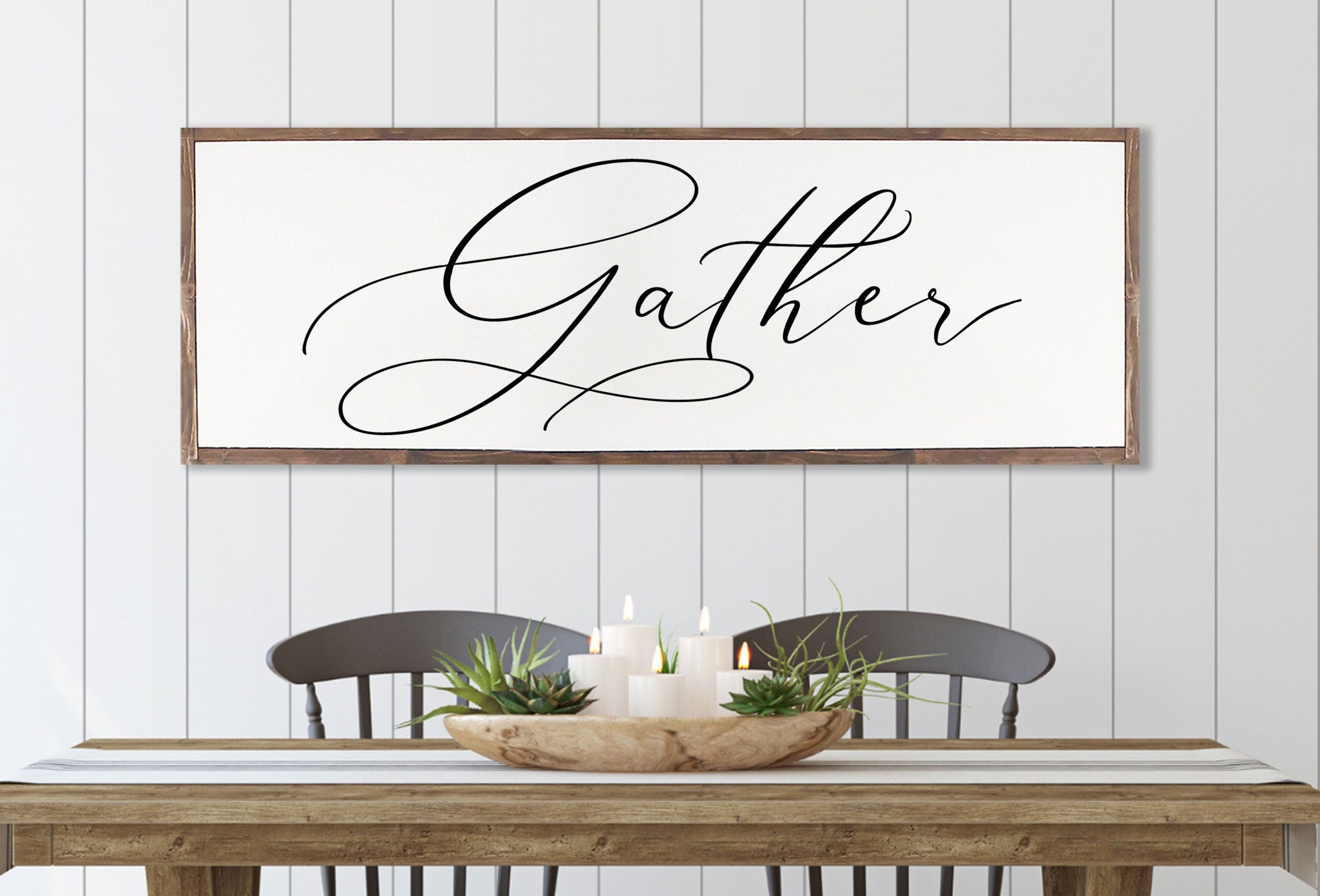 Gather Sign featuring a rustic wood design with the quote 'Bless the food before us' framed in a customizable color.