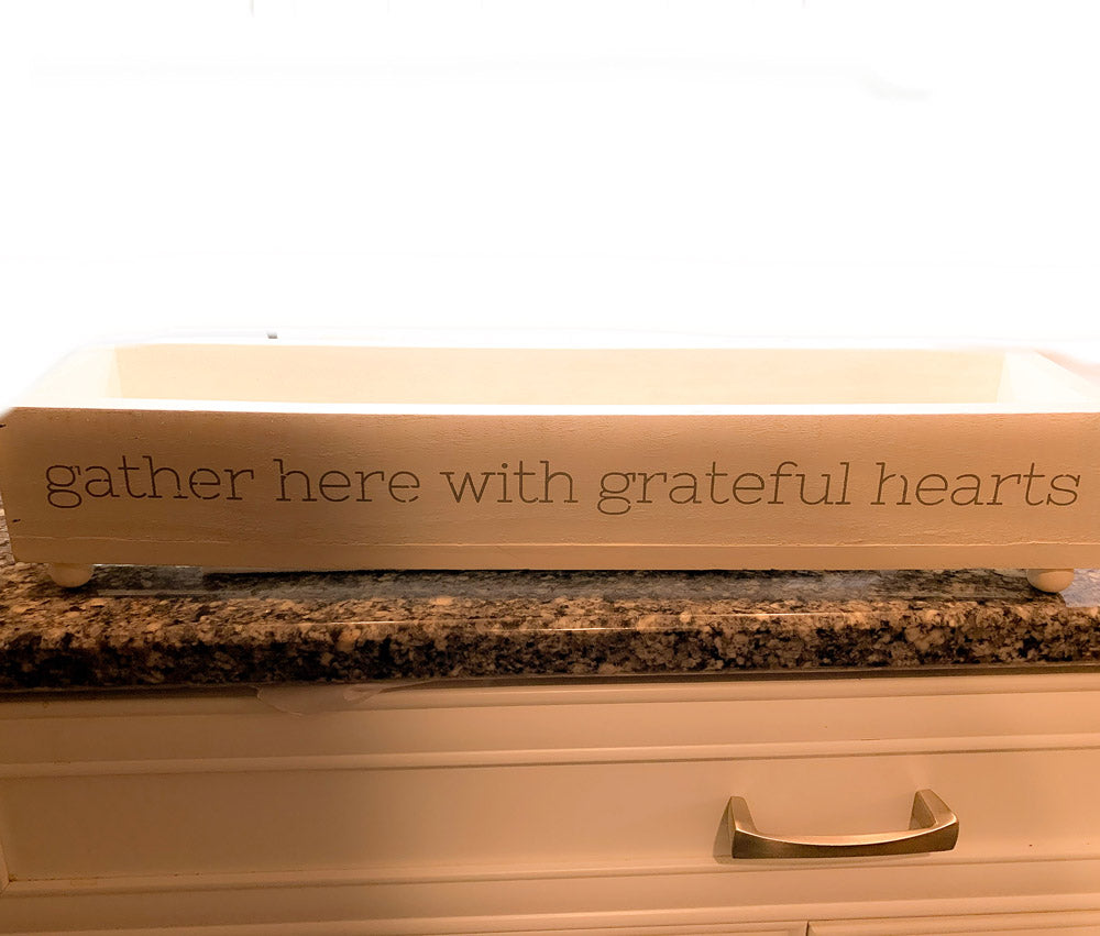 Handmade Gather Tray with the inscription 'Gather Here With Grateful Hearts', featuring round peg feet for elevation.