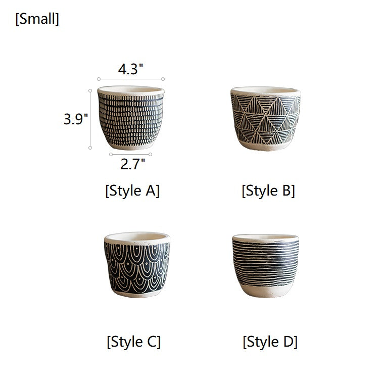 Geometric Art Concrete Flower Pot in black and cream colors, showcasing its modern design and drainage hole.