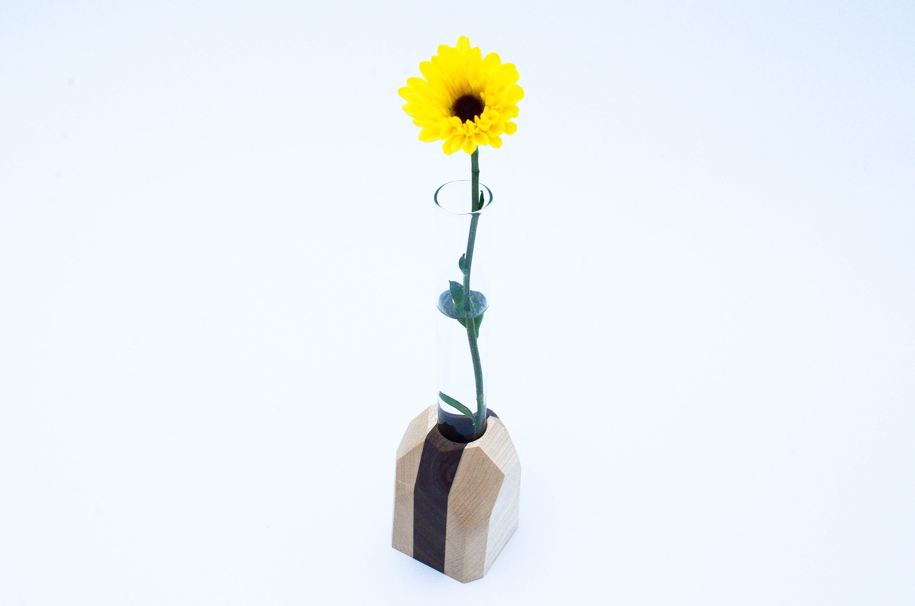 A handcrafted Geometric Flower Vase made from Maple and Black Walnut hardwood, showcasing its modern design and unique wood grain patterns.