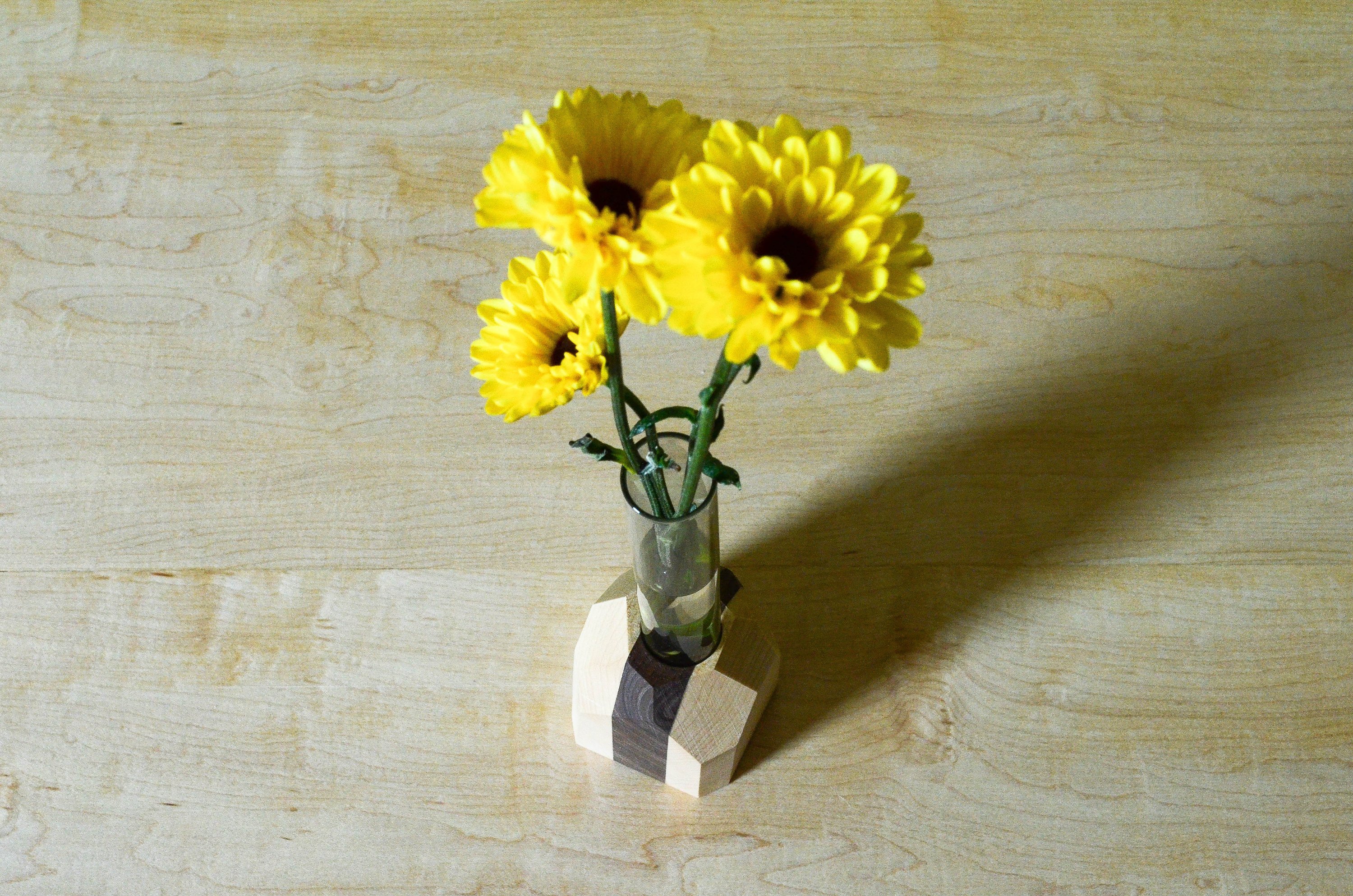 A handcrafted Geometric Flower Vase made from Maple and Black Walnut hardwood, showcasing its modern design and unique wood grain patterns.