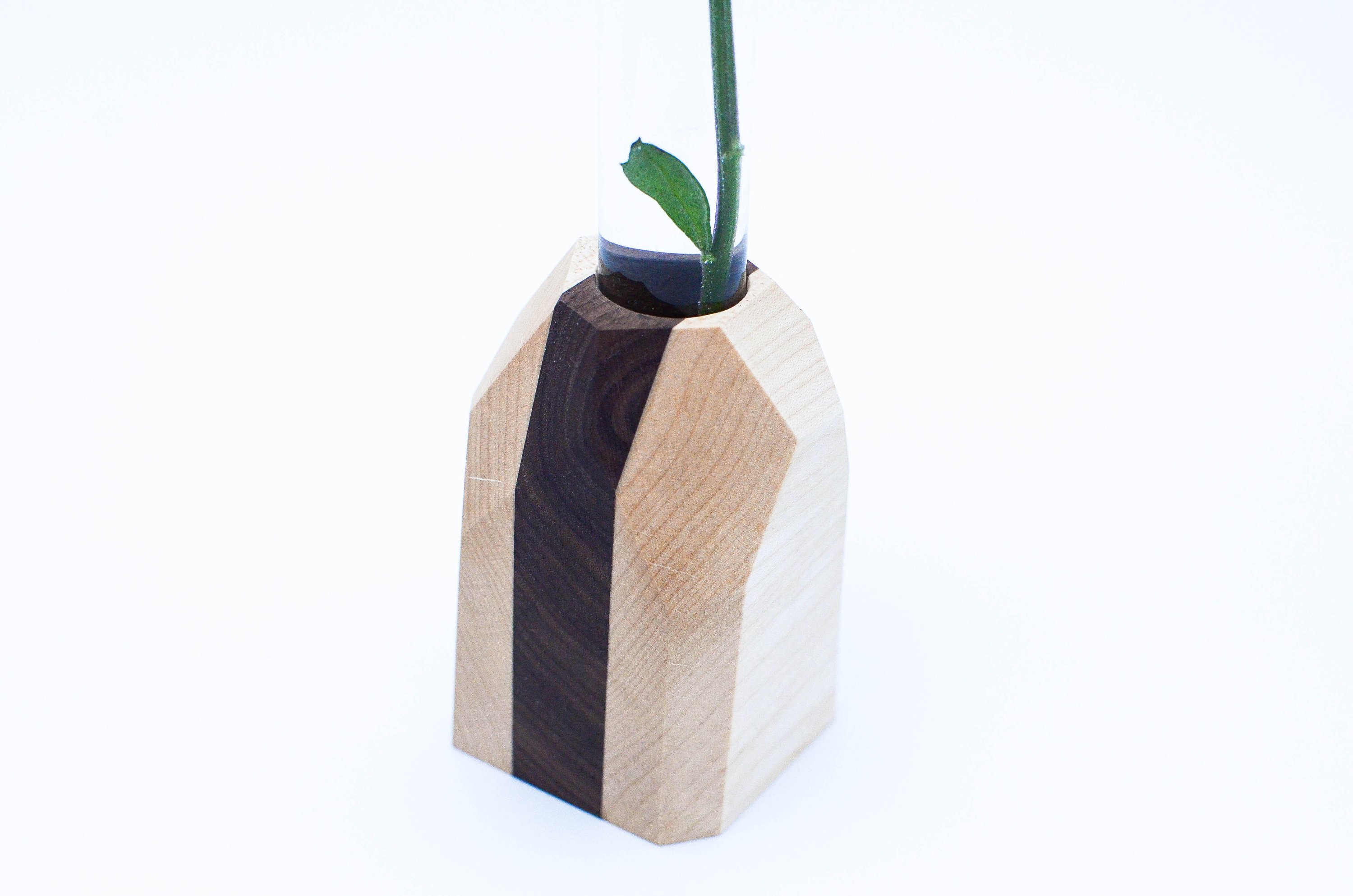 A handcrafted Geometric Flower Vase made from Maple and Black Walnut hardwood, showcasing its modern design and unique wood grain patterns.