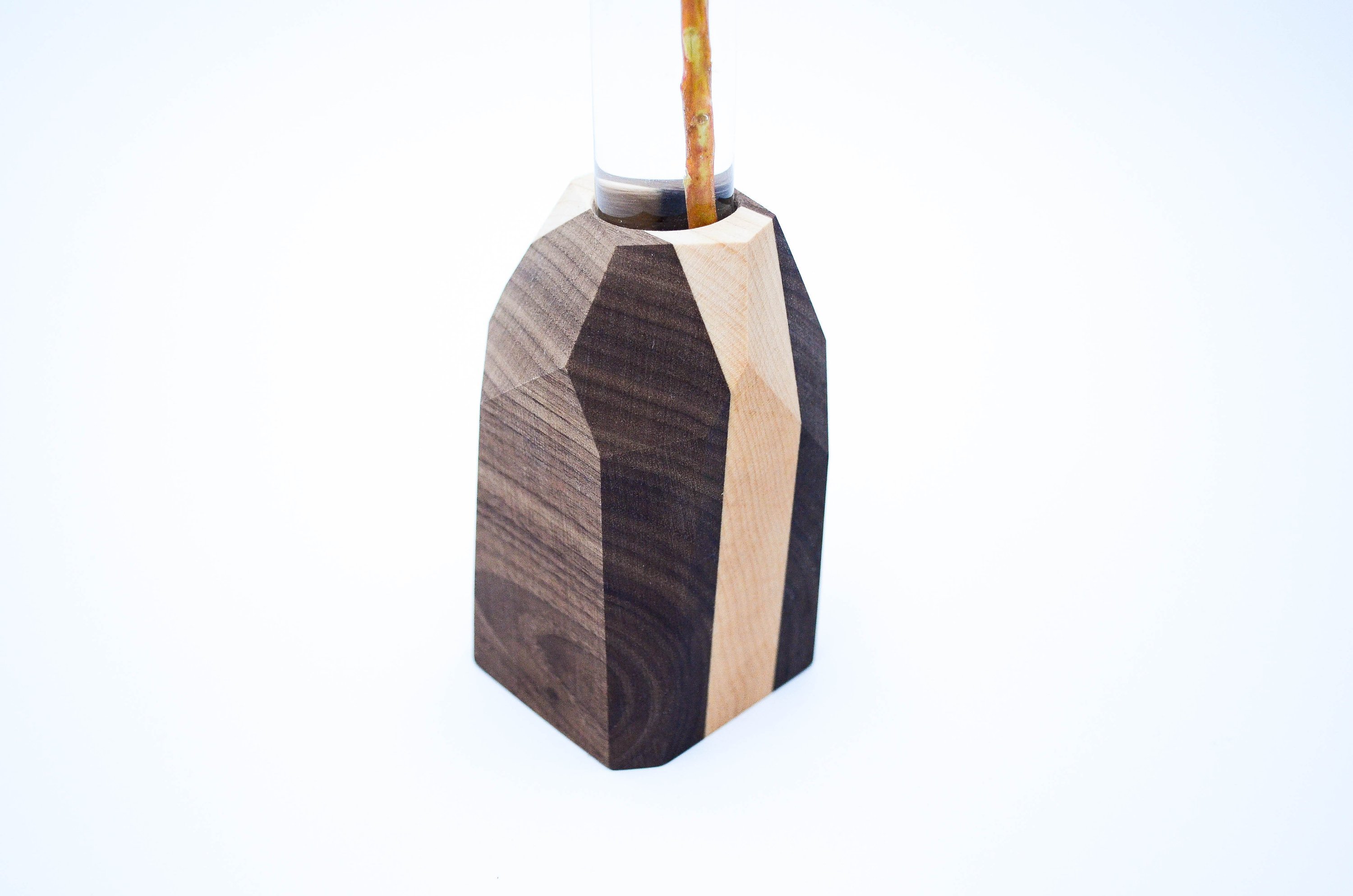 A handcrafted Geometric Flower Vase made from Maple and Black Walnut hardwood, showcasing its modern design and unique wood grain patterns.