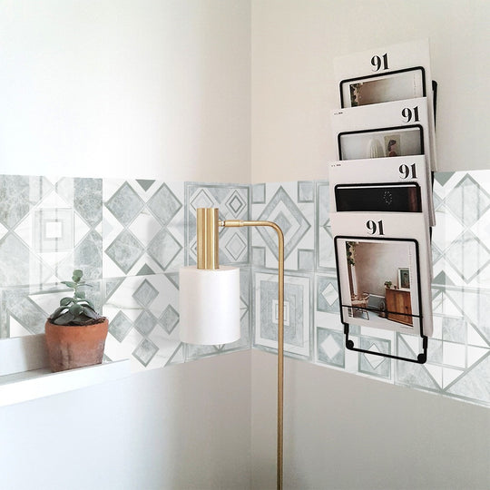 Geometric pattern staircase wall tile stickers displayed on a kitchen backsplash, showcasing their vibrant design and glossy finish.