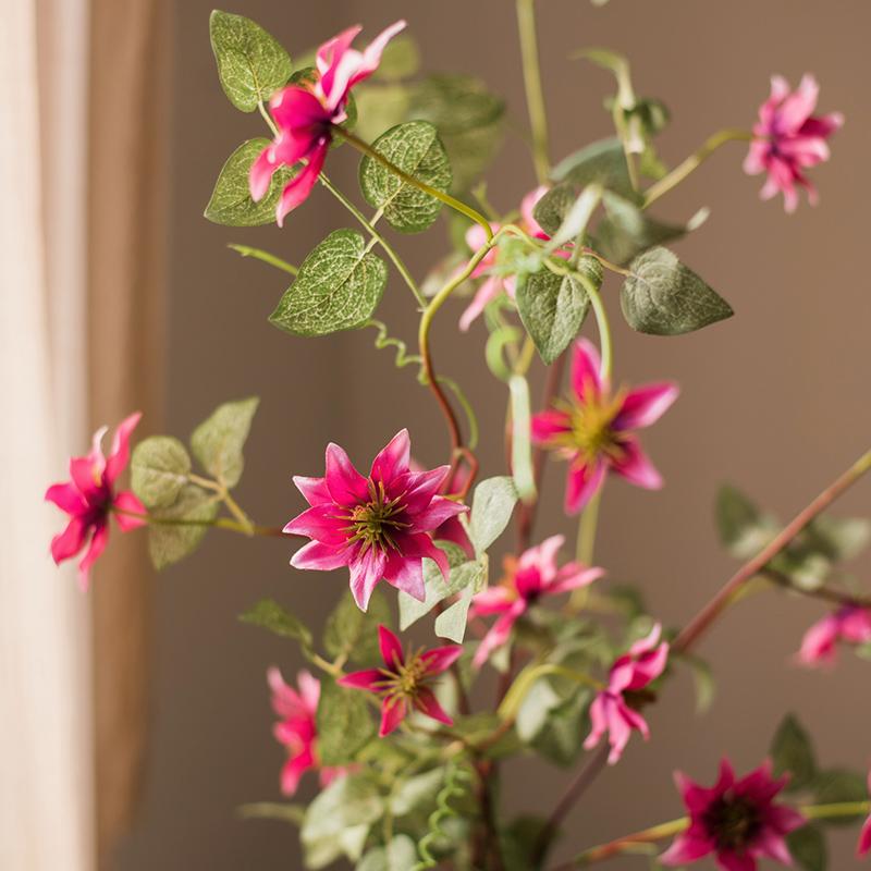 A 40-inch tall German Clematis flower stem in rose pink, featuring seven lifelike silk flowers and green leaves, perfect for home decor.