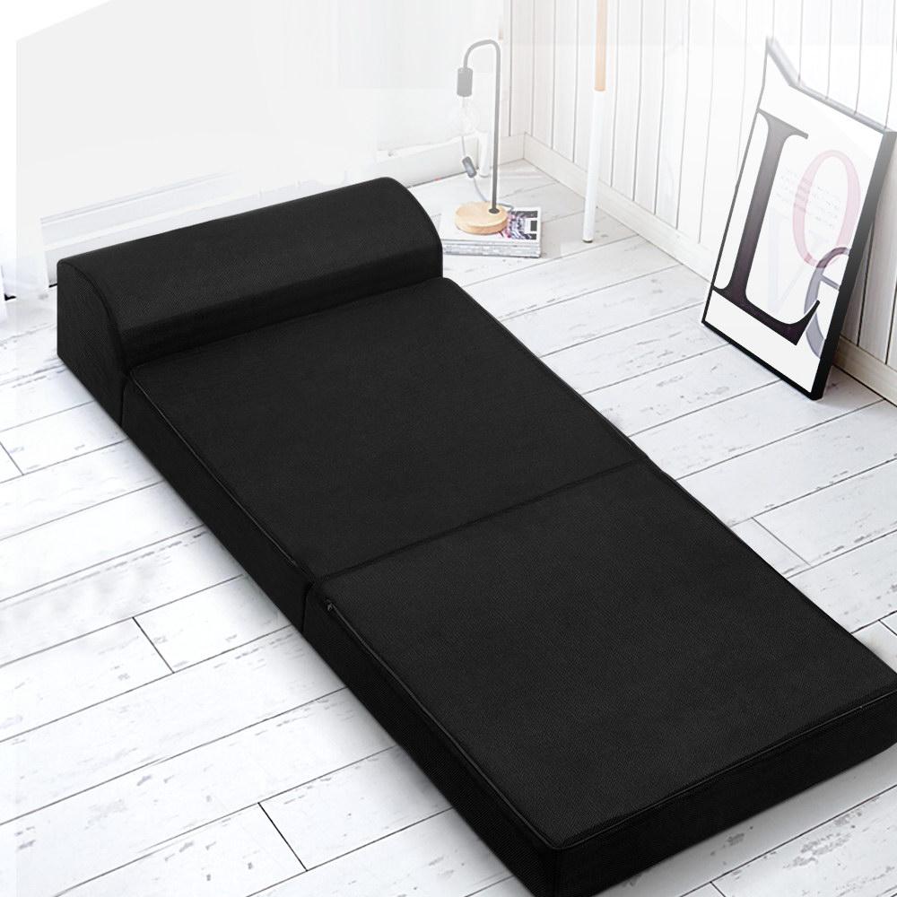 Giselle Bedding Folding Foam Mattress in black, showcasing its dual functionality as a sofa and bed, with a removable cover.