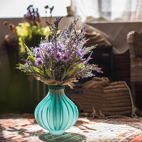 A beautifully crafted hand blown frosted art glass vase in yellow, blue, and gray, showcasing unique textures.