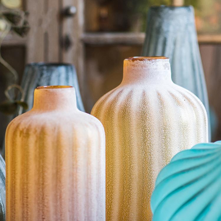 A beautifully crafted hand blown frosted art glass vase in yellow, blue, and gray, showcasing unique textures.