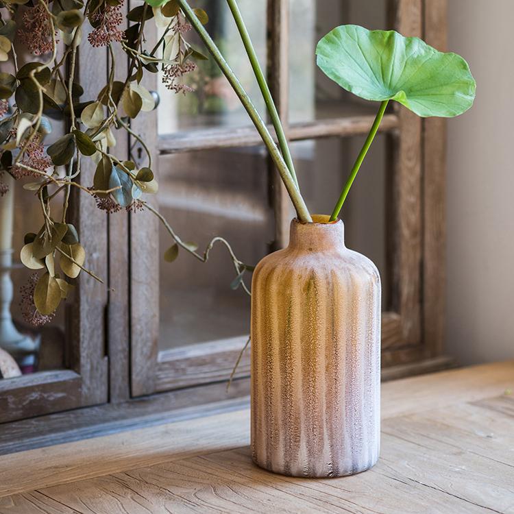 A beautifully crafted hand blown frosted art glass vase in yellow, blue, and gray, showcasing unique textures.