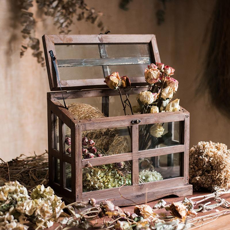 A stylish Glass Wood Display Box showcasing collectibles, featuring a clear glass top and a wooden base in brown sycamore.