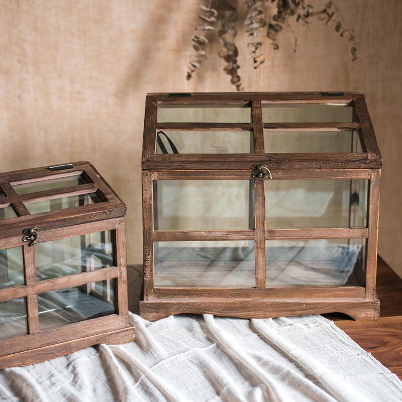 A stylish Glass Wood Display Box showcasing collectibles, featuring a clear glass top and a wooden base in brown sycamore.