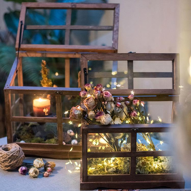 A stylish Glass Wood Display Box showcasing collectibles, featuring a clear glass top and a wooden base in brown sycamore.