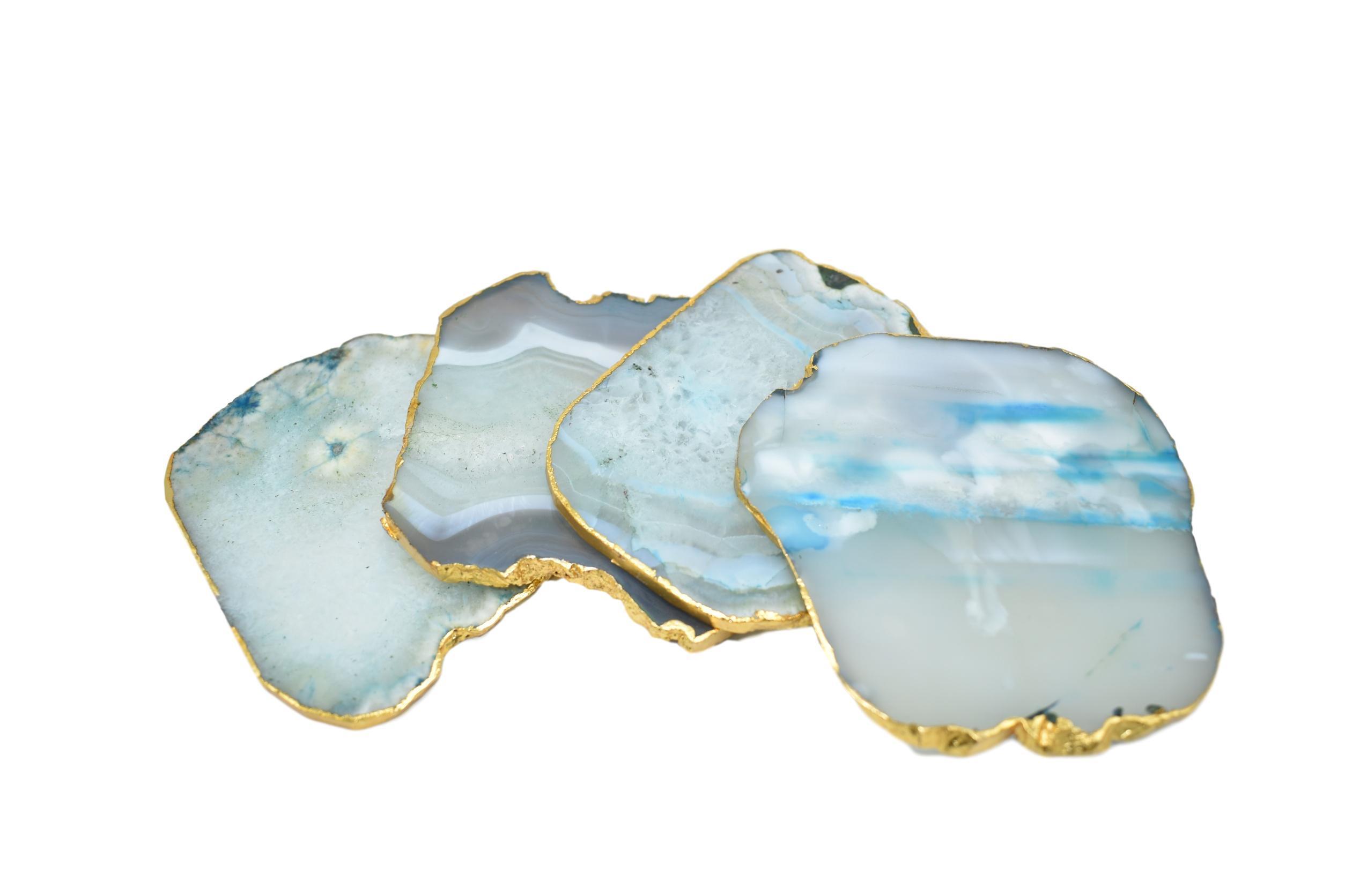 Set of four gnarled agate coasters with gold trim, showcasing unique natural patterns and vibrant colors.